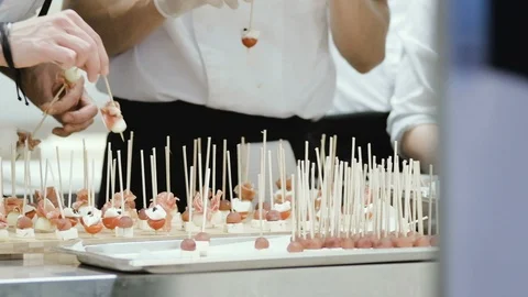 Chef preparing and decorating food, canapés and snacks for a buffet table Stock Footage 93358240