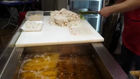 Chef Preparing and Deep Frying Fresh Korean Fish Cakes (Eomuk) at a Street Food Stock Footage 337373004