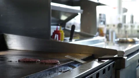 Chef preparing and wrapping a cheeseburger in a restaurant Stock Footage 83413539