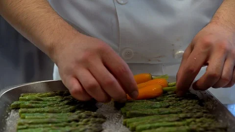 Chef preparing asparagus and carrot on a tray Stock Footage 107873554