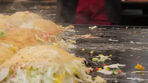 Chef Preparing Authentic Japanese Hiroshima-Style Okonomiyaki Savory Pancakes on Stock-Footage 347688902