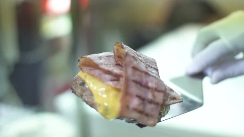 Chef preparing bacon cheeseburger in kitchen Stock Footage 98239072