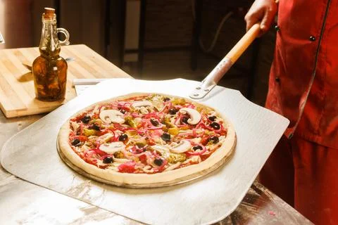 Chef preparing to bake a pizza Stock Photos