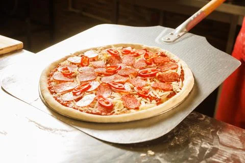 Chef preparing to bake a pizza Stock Photos