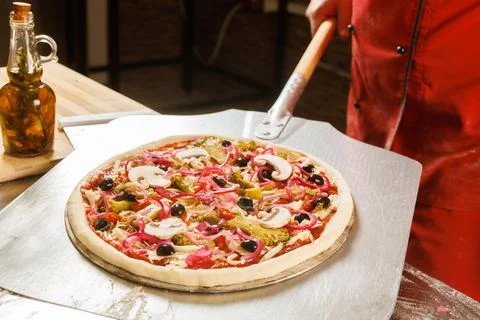 Chef preparing to bake a pizza Stock Photos