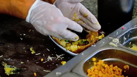 Chef is preparing baked stuffed potato with various ingredients. Stock Footage 152956987