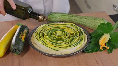 The chef is preparing a beautiful pie with colorful zucchini, Tuscan pie Stock Footage 264141598