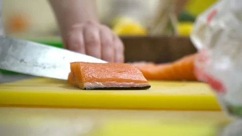 Chef is preparing beautiful salmon on the cutting board, peeling the skin, 4k Stock Footage 129323211