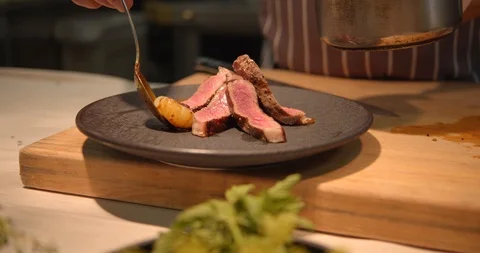 Chef Preparing Beef &amp; Potatoes Dish in Luxury Steak Restaurant Stock Footage 127526412