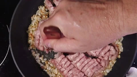 The chef is preparing a bolognese. Golden fried onions in fizzy olive oil. Th Stock Footage 204686163