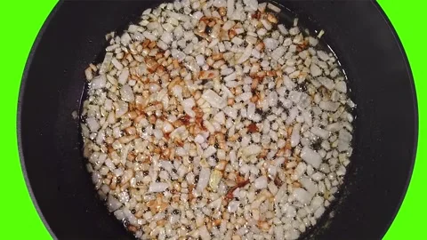 The chef is preparing a bolognese. Golden fried onions in sizzling olive oil. Stock Footage 204854683