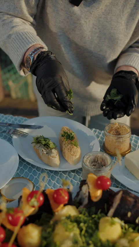 Chef preparing bread appetizer with herbs and spreads Stock Footage 310006639