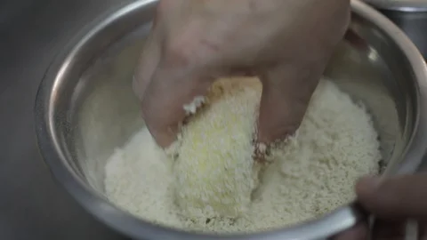 Chef Preparing a Breaded Brie Cheese with White Flour, Eggs and Panko Flour Stock Footage 129335920