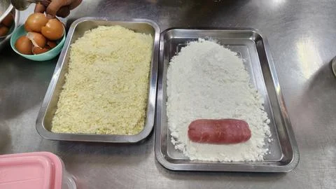 Chef Preparing Breading Station with Meat Flour and Breadcrumbs for Deep Fryi Stock Photos