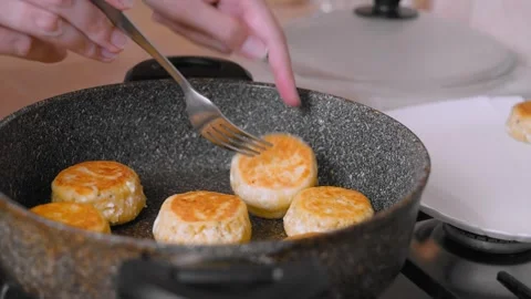 Chef Preparing Breakfast With Sizzling Pancakes In Heavy Skillet Stock Footage 330025294