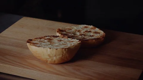 Chef preparing the burger. Close up - Hand Of man Smears Sauce Fried Burger For Stock Footage 97575971