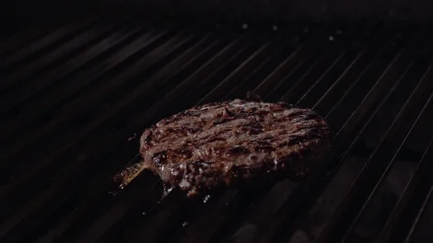 Chef preparing the burger, frying the bun on the grill, putting sauce on meat Stock Footage 97575432