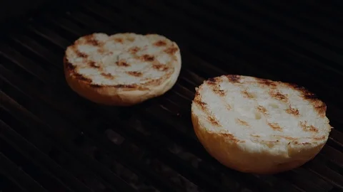 Chef preparing the burger, frying the bun on the grill Stock Footage 97575865