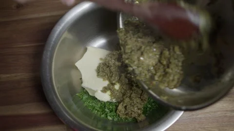 A chef preparing a café de paris sauce. Mixing all ingredients in a metal Stock Footage 254073148
