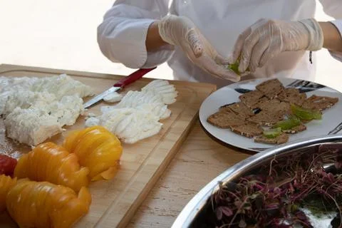 Chef preparing caprese style appetizer with fresh mozzarella and heirloom t.. Stock Photos