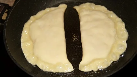 Chef preparing cheburek. Cooking process. Cooking pies. Fried meat pies Stock Footage 98486113