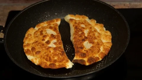 Chef preparing cheburek. Cooking process. Cooking pies. Fried meat pies Stock Footage 98486131