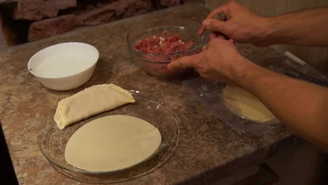 Chef preparing cheburek. Cooking process. Cooking pasties. Minced meat Stock Footage 98486356