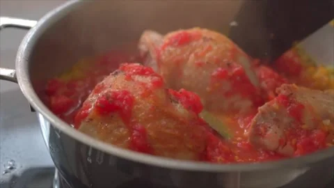A chef preparing Chicken Cacciatore (Italian chicken stew) Stock Footage 318850619