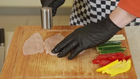 Chef preparing chicken fillet and vegetables for baking in an oven Stock Footage 340552185