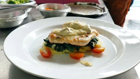 Chef preparing chicken steak on white dish Stock Footage 81537049