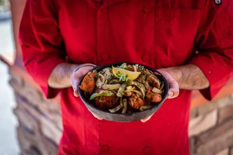 Chef preparing cooking and serving indian cuisine dish Stock Photos
