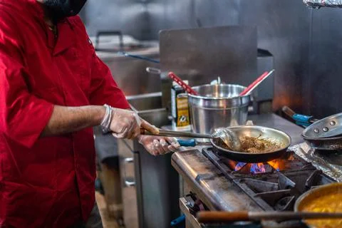 Chef preparing cooking and serving indian cuisine dish Stock-Fotos