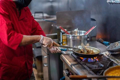Chef preparing cooking and serving indian cuisine dish Stock Photos