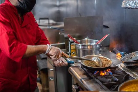 Chef preparing cooking and serving indian cuisine dish Stock Photos