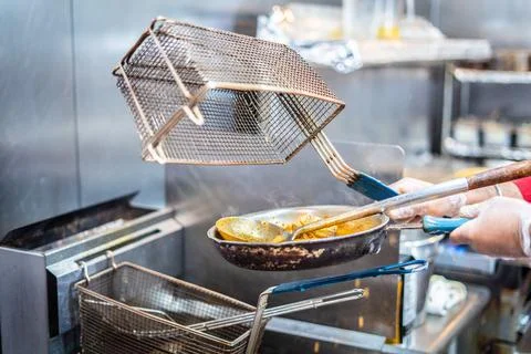 Chef preparing cooking and serving indian cuisine dish Stock Photos