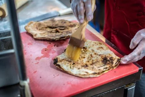 Chef preparing cooking and serving indian cuisine dish Stock Photos