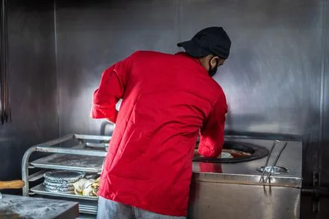 Chef preparing cooking and serving indian cuisine dish Stock Photos