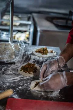 Chef preparing cooking and serving indian cuisine dish Stock Photos