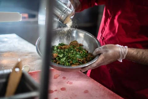 Chef preparing cooking and serving indian cuisine dish Stock Photos