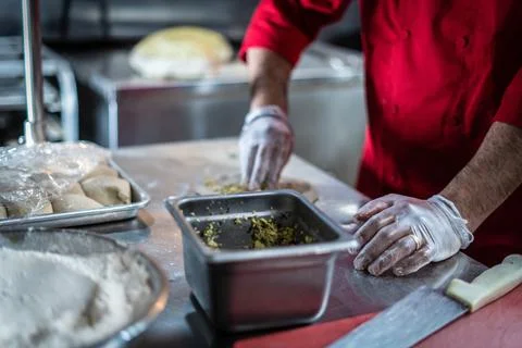 Chef preparing cooking and serving indian cuisine dish Stock Photos