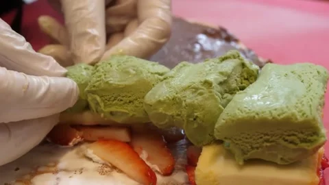 Chef Preparing Crepe with Matcha Ice Cream, Strawberries, and Cake 스톡 동영상 345692050