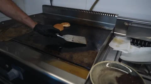 The chef is preparing delicious smashed burgers in the kitchen Stock Footage 294955272
