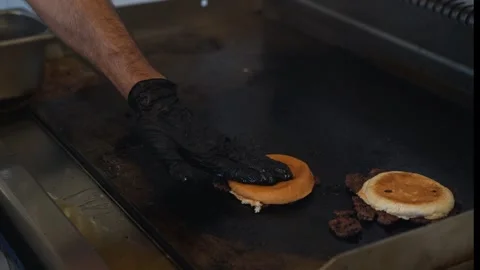 The chef is preparing delicious smashed burgers in the kitchen Stock Footage 294955384