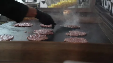 The chef is preparing delicious smashed burgers in the kitchen Stock Footage 294955784