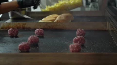 The chef is preparing delicious smashed burgers in the kitchen Stock Footage 294955861