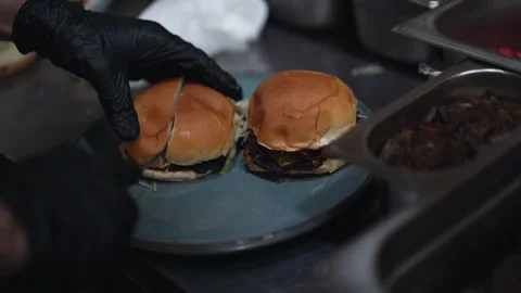 The chef is preparing delicious smashed burgers in the kitchen Stock Footage 294955879