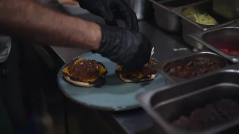 The chef is preparing delicious smashed burgers in the kitchen Stock Footage 294955944