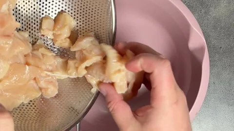 Chef preparing dinner. Man putting chopped raw chicken meat to bowl Stock Footage 308344460
