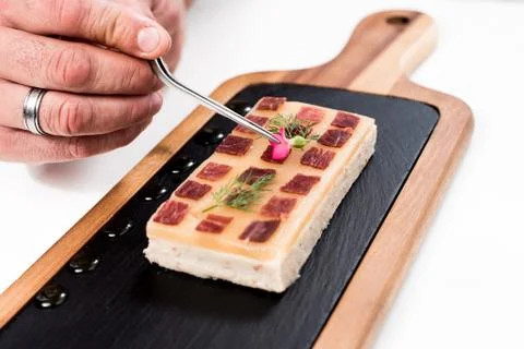Chef preparing a dish with Iberian ham Stock Photos