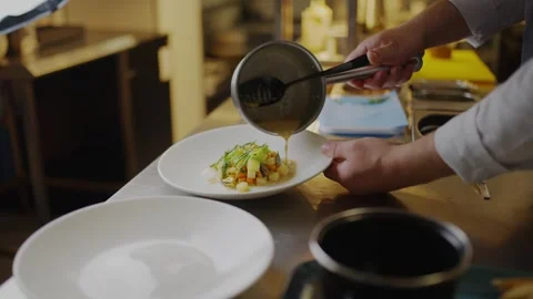 A chef is preparing a dish with a spoon Video stock 306576945